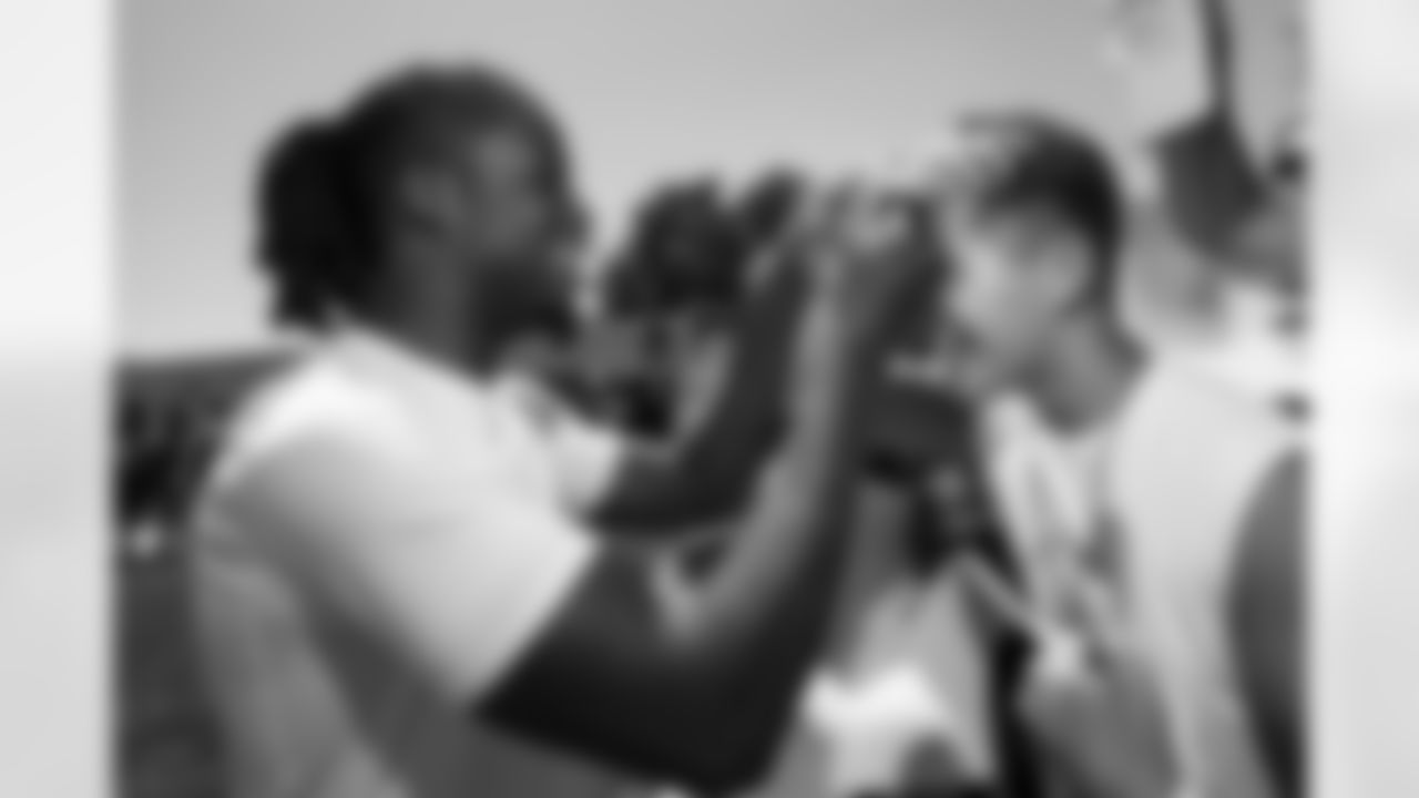 Jerry Jeudy autographs a fan's forehead during a training camp practice at Centura Health Training Center on August 17, 2023 in Englewood, Colorado. Photo by Ben Swanson / Denver Broncos