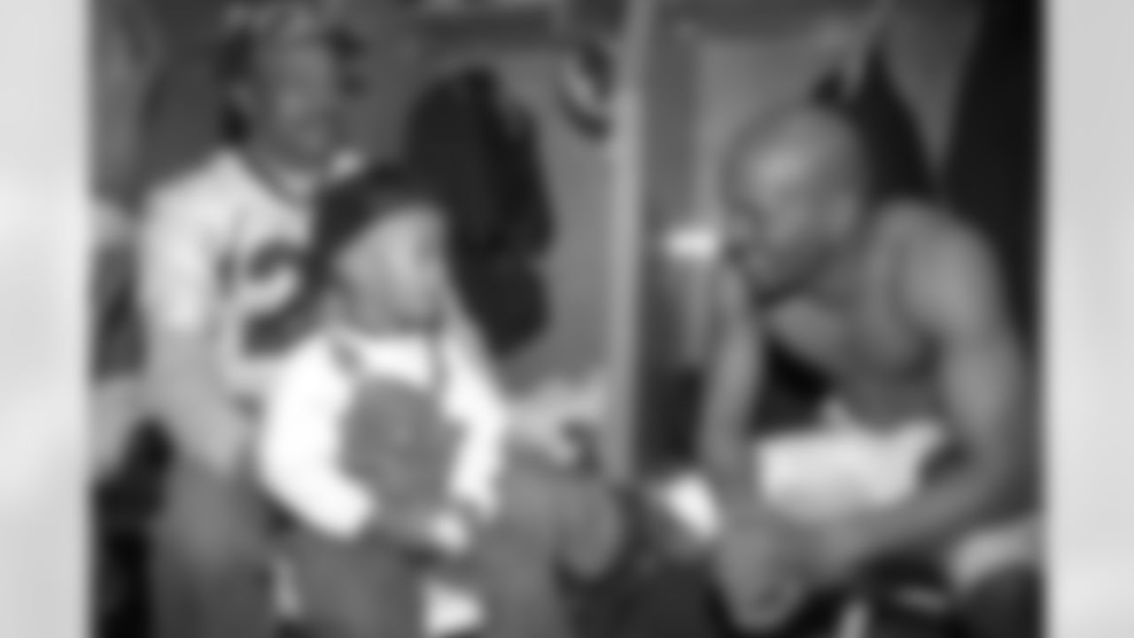 San Diego: Randy Hilliard relaxes in the locker room with family members during the post-game celebration against the Green Bay Packers at Qualcomm Stadium in San Diego, CA on January 25, 1998.