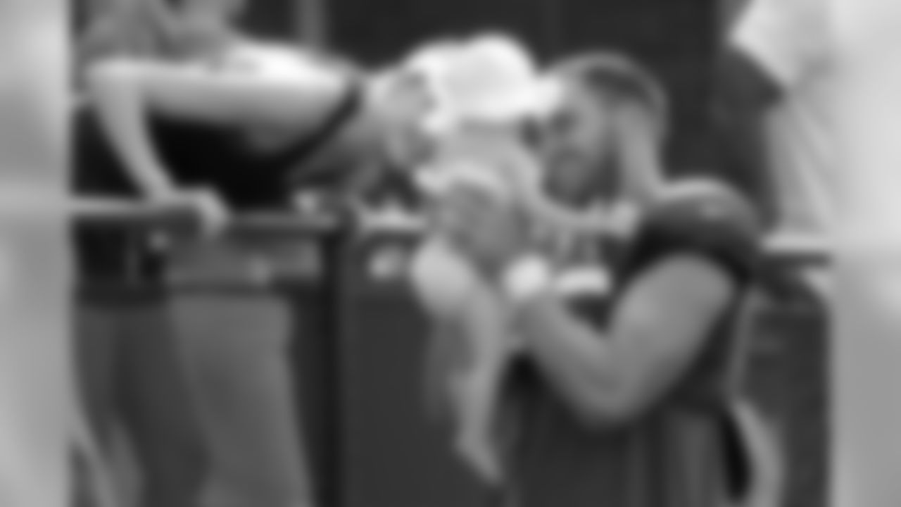 New York Giants running back Rhett Ellison, right, holds his 9-month-old daughter, Kaia, as his wife, Raina Ellison, looks on at the end of a workout during NFL football training camp, Wednesday, Aug. 1, 2018, in East Rutherford, N.J. (AP Photo/Julio Cortez)