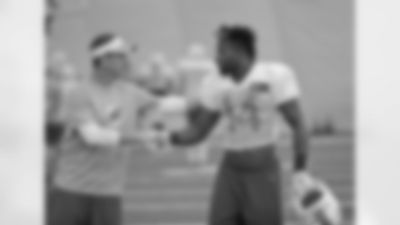 FILE- In this Tuesday, Aug. 4, 2015 file photo, Miami Dolphins defensive coordinator Lou Anarumo, left, chats with wide receiver Jarvis Landry (14) at the teams NFL football training camp in Davie, Fla. The early reviews of the new Dolphins defensive coordinator are like the team's results during this up-and-down season: mixed. Sunday's game at Buffalo will help determine whether the defense has improved under Anarumo. (AP Photo/Wilfredo Lee, File)