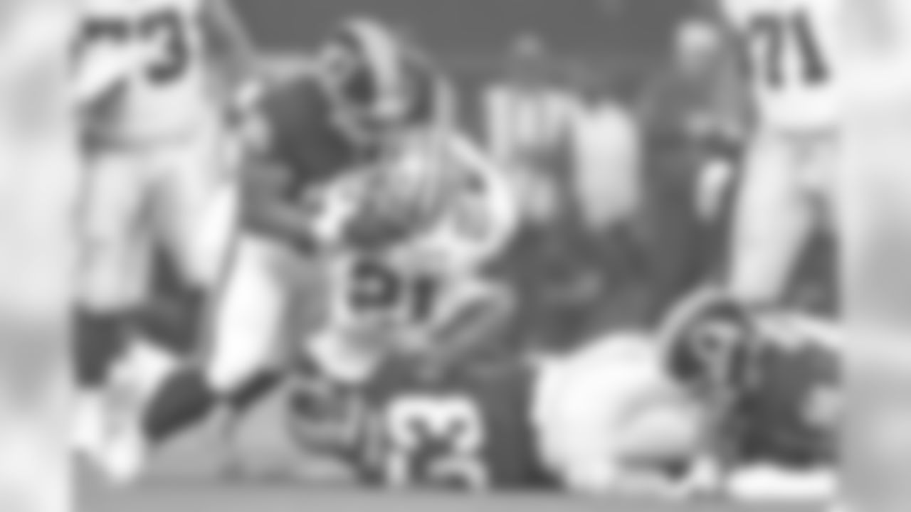 Dallas Cowboys running back Ezekiel Elliott (21) is tackled after a gain by Washington Redskins linebacker Zach Brown (53) and defensive tackle Daron Payne (95) during a 2018 NFL week 12 regular season game, Thursday, Nov. 22, 2018 in Arlington, Texas. The Cowboys defeated the Redskins,31-23. (James D. Smith via AP)