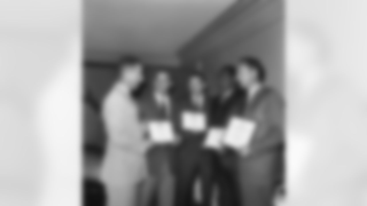 Four National Football League stars receive citations, in Washington on May 18, 1966, for providing entertainment to the armed forces during a tour of Vietnam in winter. From left: Lt. Gen. James K. Woolnough, presenting awards on behalf of the Defense Department; Sam Huff of the Washington Redskins; Johnny Unitas of the Baltimore Colts; Willie Davis of the Green Bay Packers; and Frank Gifford, formerly with the New York Giants and now a television broadcaster. (AP Photo/Bob Schutz)