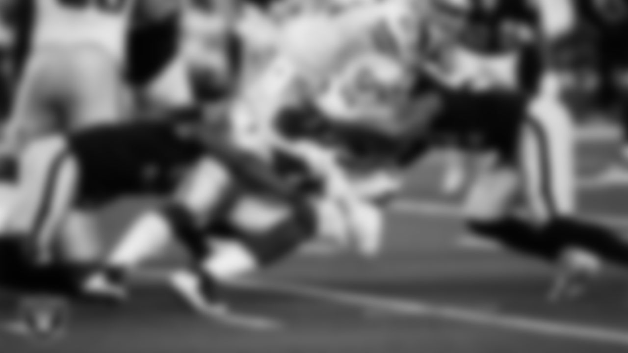 Las Vegas Raiders defensive end Yannick Ngakoue (91) and linebacker Denzel Perryman (52) make a tackle during the regular season away game against the Dallas Cowboys.