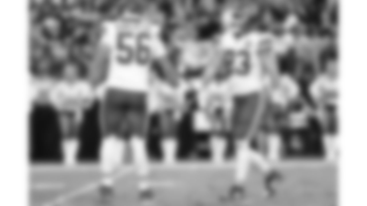 Kansas City Chiefs middle linebacker Drue Tranquill (23) and defensive end George Karlaftis (56) high five during the NFL Week 8 matchup against the Las Vegas Raiders on Sunday, October 27, 2024 in Las Vegas, NV.