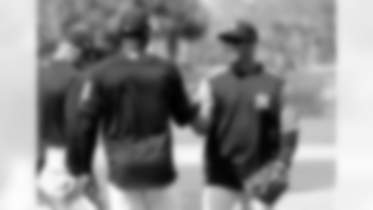 Seattle Seahawks NFL football team quarterback Russell Wilson, right, shakes hands with shortstop Didi Gregorius (18) at New York Yankees baseball spring training camp, Monday, Feb. 26, 2018, in Tampa, Fla. (AP Photo/Lynne Sladky)