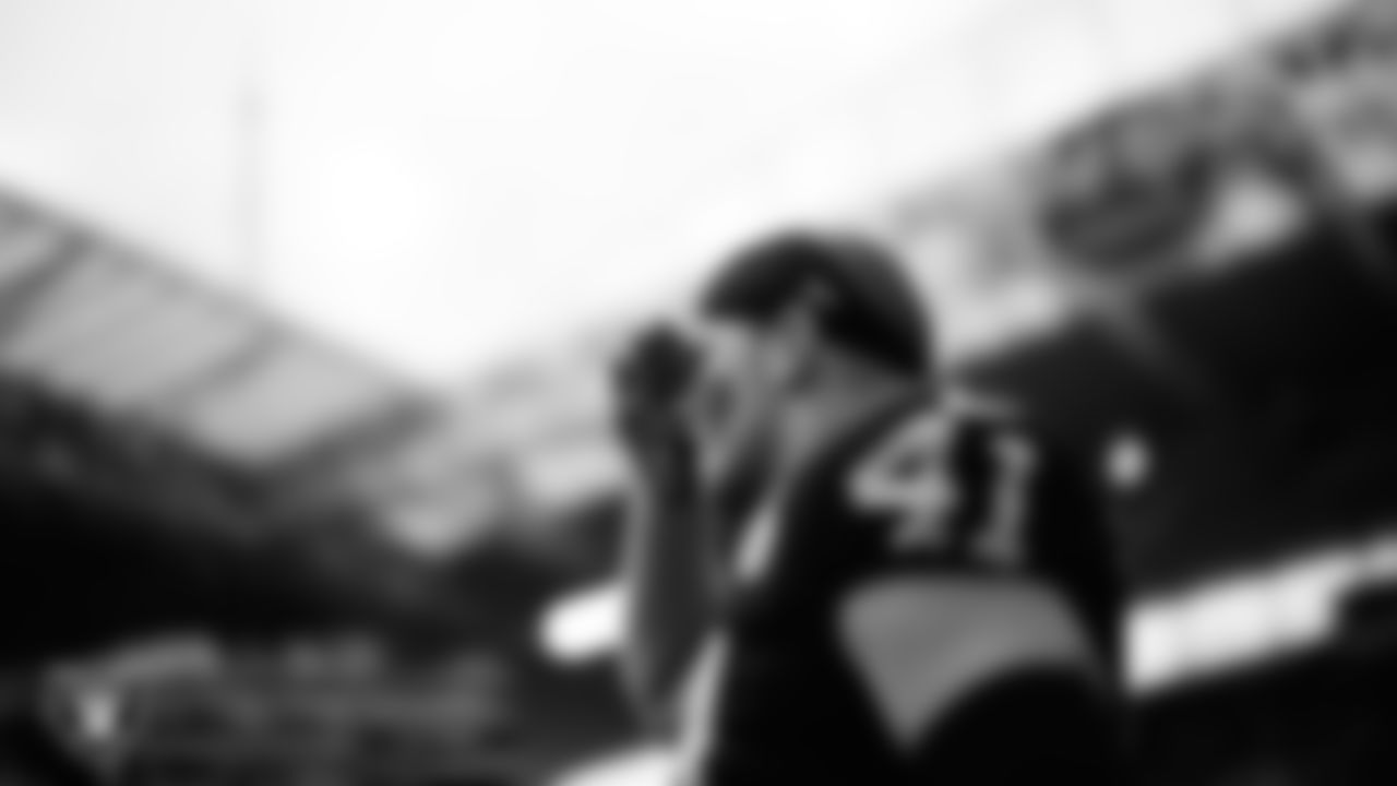 Las Vegas Raiders linebacker Robert Spillane (41) salutes service members during the national anthem before the regular season away game against the Miami Dolphins at Hard Rock Stadium.