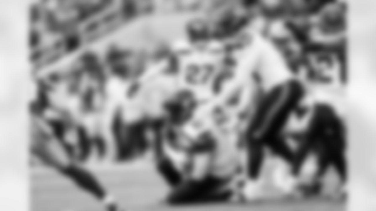 Seahawks defensive tackle Johnathan Hankins cradles an interception off of a pass tipped by teammate Devon Witherspoon.