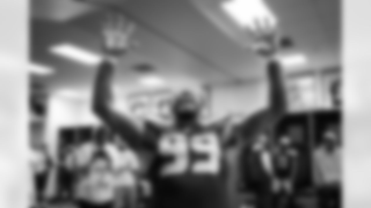 After the game, Leonard Williams celebrates in the locker room sporting the now-famous "WIN" glasses.